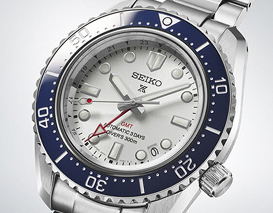 Close-up of Seiko Prospex GMT diver&rsquo;s watch with white dial, blue rotating bezel and red GMT hand